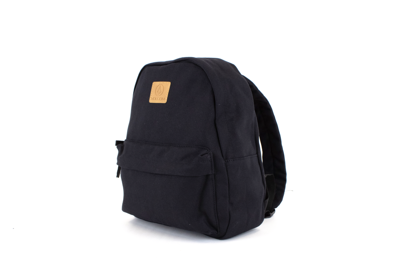 A side-angle view of the Volcom Women's Winnie Backpack in solid black, ideal for carrying your everyday essentials, featuring a tan square patch with the Volcom logo on the front, set against a plain white background.