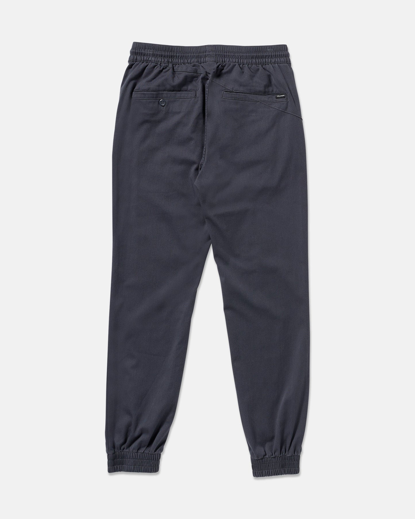 The Volcom Men's Frickin Slim Joggers in dark gray are shown from the back, featuring an elastic waistband, slim fit, two back pockets (one with a button), and made from REPREVE recycled fibers on a plain white background.