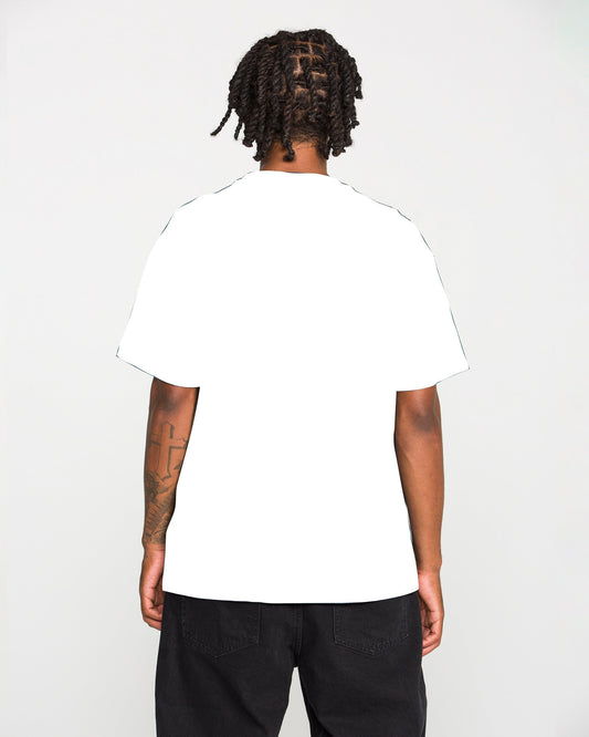 A person with short dreadlocks, seen from behind, is wearing the Volcom Men's Studded Short Sleeve Tee in white and black pants, standing against a light gray background.