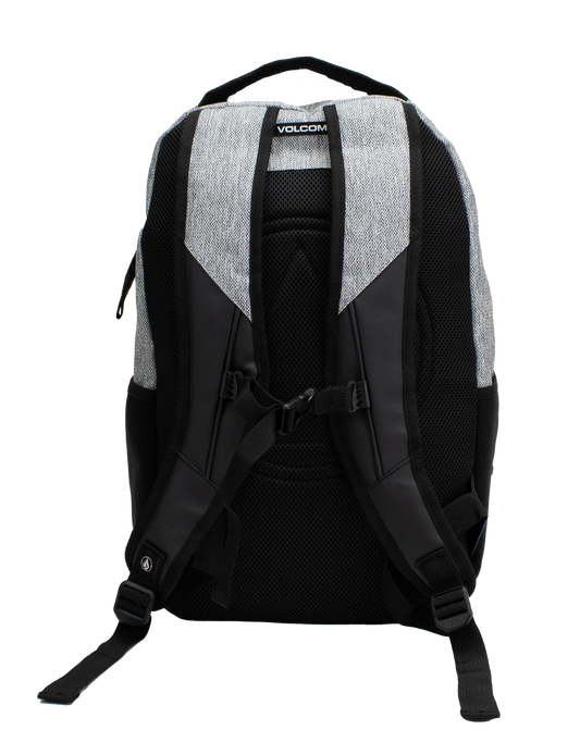 A back view of the Volcom Men's Grindstone Skate Backpack in gray and black, displaying padded shoulder straps, adjustable straps, a top handle, side mesh pockets, a padded laptop sleeve, and an adjustable chest strap against a white background.