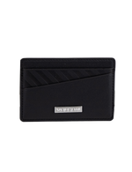 The Volcom Men's Primo Dos Cardholder features a sleek black design with diagonal textured lines on the top left and is accented by a silver metal plate engraved with "VOLCOM" at the bottom center, displayed against a plain white background.