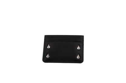 A Volcom Women's Studette Card Wallet in black, featuring a slim design with three card slots and four silver pyramid studs—two on each side—displayed against a plain white background.
