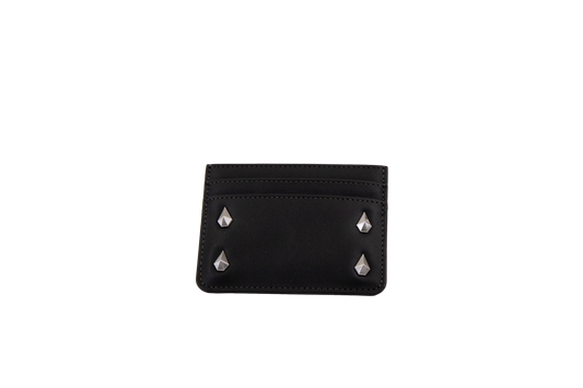 A Volcom Women's Studette Card Wallet in black, featuring a slim design with three card slots and four silver pyramid studs—two on each side—displayed against a plain white background.