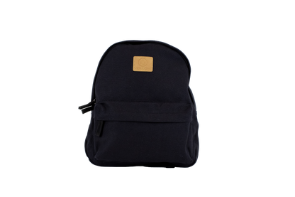 The Volcom Women's Winnie Backpack is a black mini backpack featuring a front zipper pocket and a tan square logo patch on the upper front, ideal for carrying your everyday essentials, shown against a plain white background.