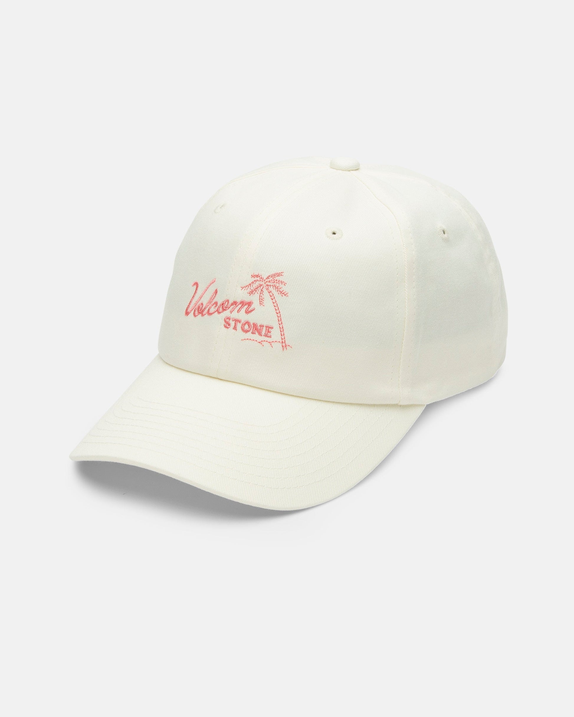 The Volcom Women's Stone Rising Hat is an ivory cotton, unstructured 6-panel hat with a pink palm tree and Welsom Stone embroidered on the front, an adjustable back strap, shown against a white background.