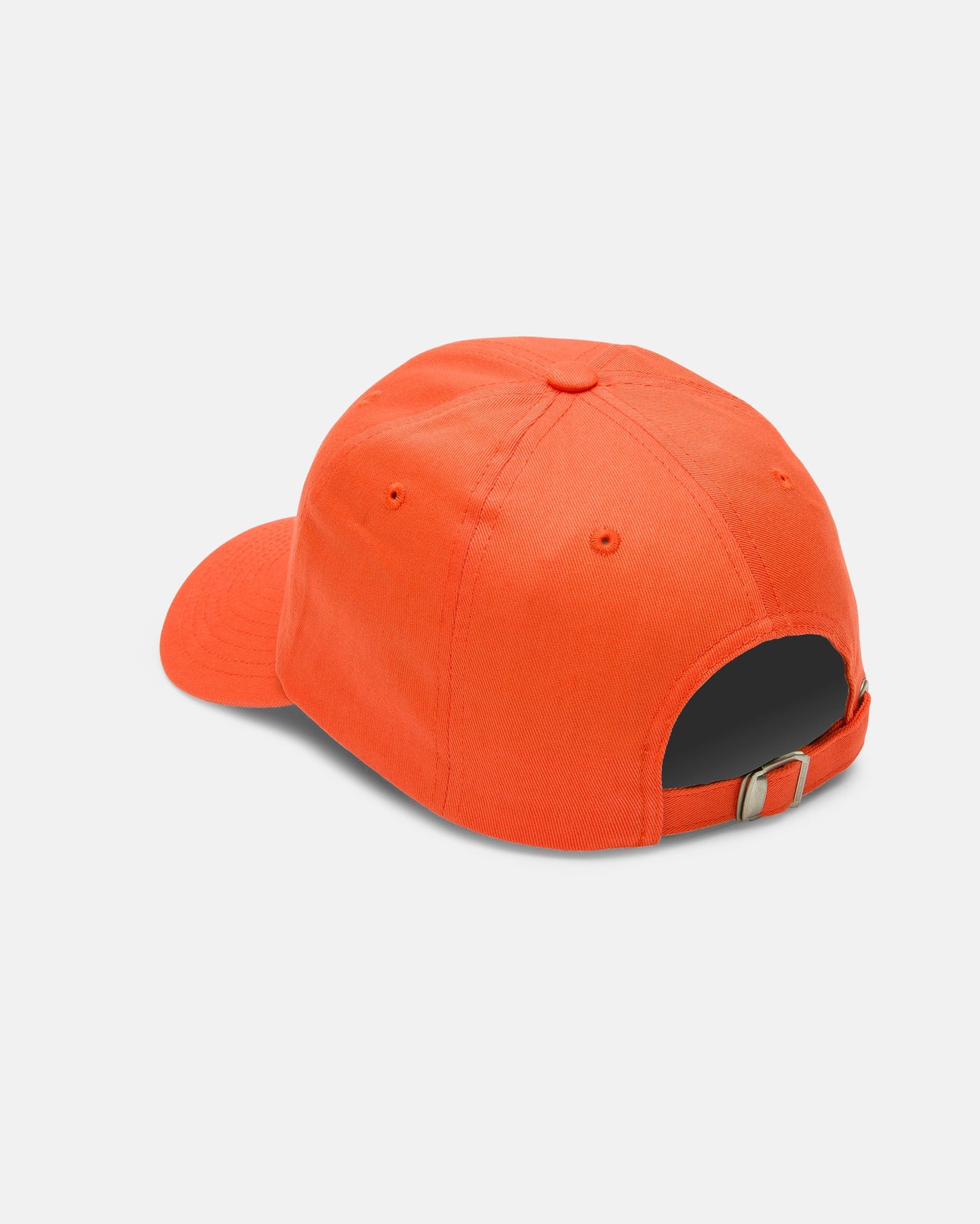 A Women's Circle Stone Dad Hat by Volcom in orange is shown from the back, highlighting its adjustable metal buckle strap. Crafted from 100% cotton and displayed on a plain white background.