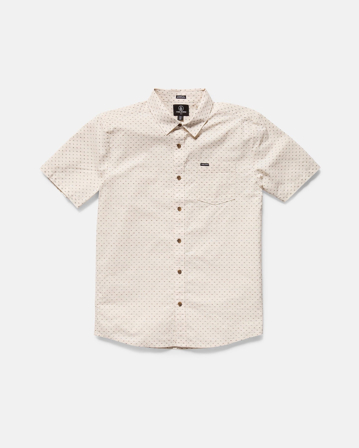 The Volcom Men's Bankstone II Short Sleeve Tee features a classic fit, beige color, subtle textured dobby dotted pattern, front chest pocket, and brown buttons, displayed laid flat on a white background.