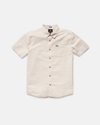 The Volcom Men's Bankstone II Short Sleeve Tee features a classic fit, beige color, subtle textured dobby dotted pattern, front chest pocket, and brown buttons, displayed laid flat on a white background.
