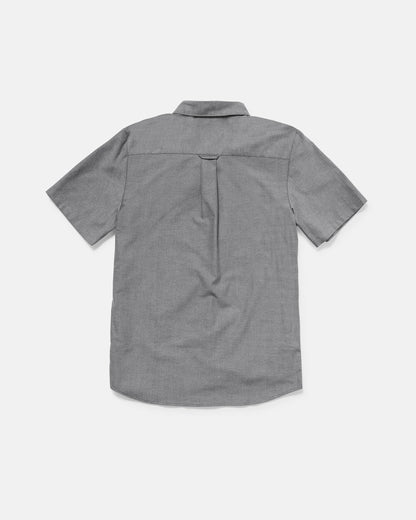 Back view of the Volcom Men's Everett Oxford II short sleeve, light gray button-up shirt with a collar and center back pleat. The classic fit oxford is laid flat on a white background.