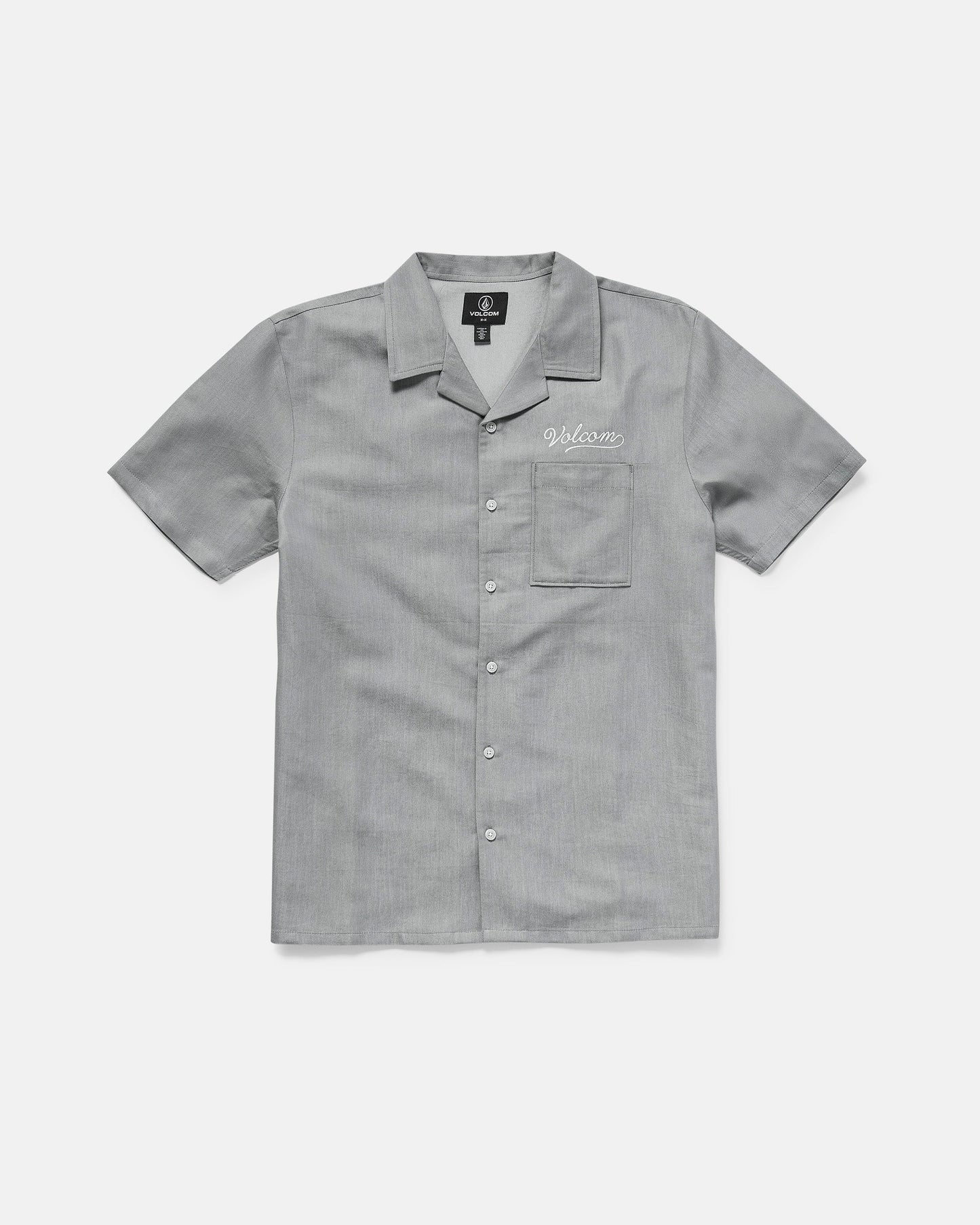 The Volcom Men's Otis Stone Short Sleeve Tee is a light gray, boxy-fit tee with a collar, made from textured fabric. It has a single chest pocket with "Welcome" embroidered above it in white.