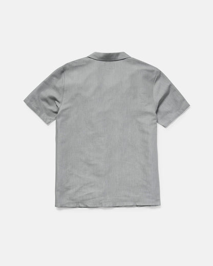 The Men's Otis Stone Short Sleeve Tee by Volcom, featuring a boxy fit and light gray color, is displayed from the back on a plain white background.