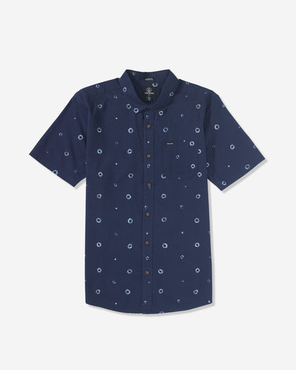 The Volcom Men's Scaler Stone Woven Short Sleeve Shirt in navy blue features subtle circular prints, a front chest pocket, and a button-down collar, shown laid flat on a white background.