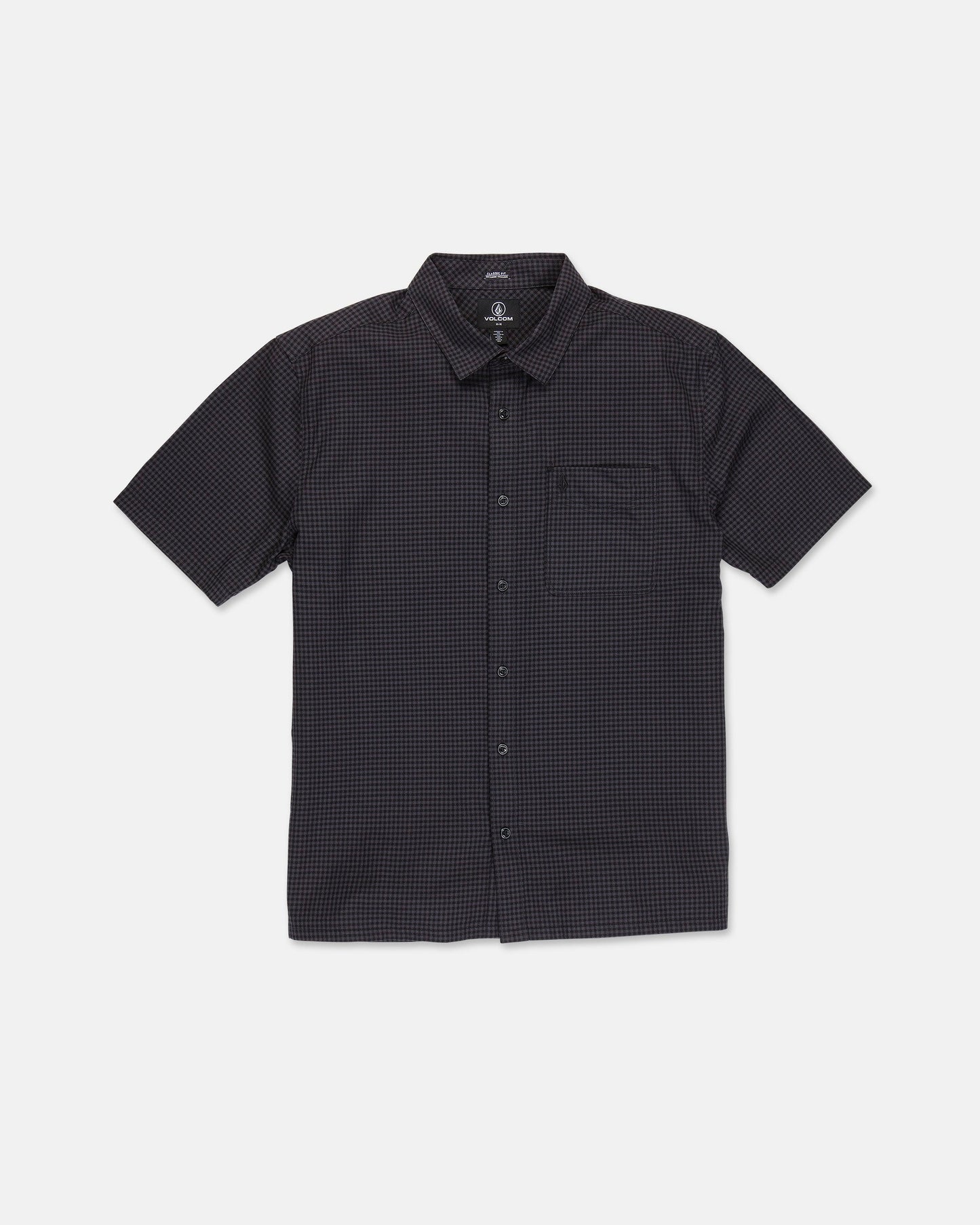 The Volcom Men's Glasnow Short Sleeve Shirt, shown laid flat on a white background, features a black cotton fabric with a subtle small yarn-dyed checkered pattern, button-up front, flat collar, and chest pocket.