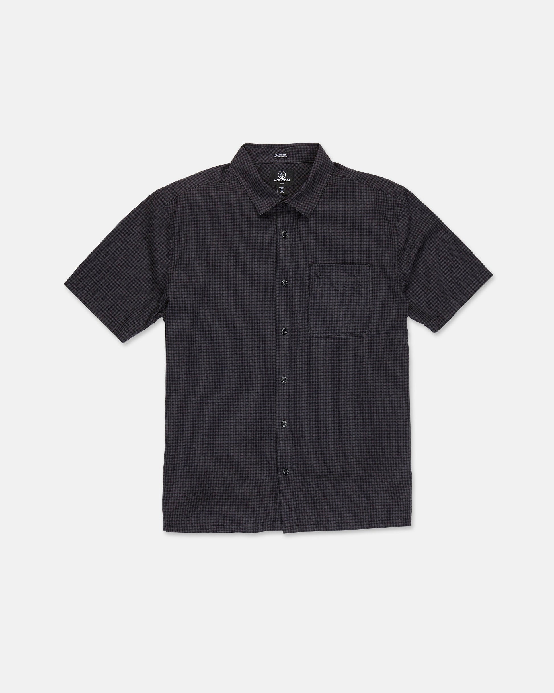 The Volcom Men's Glasnow Short Sleeve Shirt, shown laid flat on a white background, features a black cotton fabric with a subtle small yarn-dyed checkered pattern, button-up front, flat collar, and chest pocket.