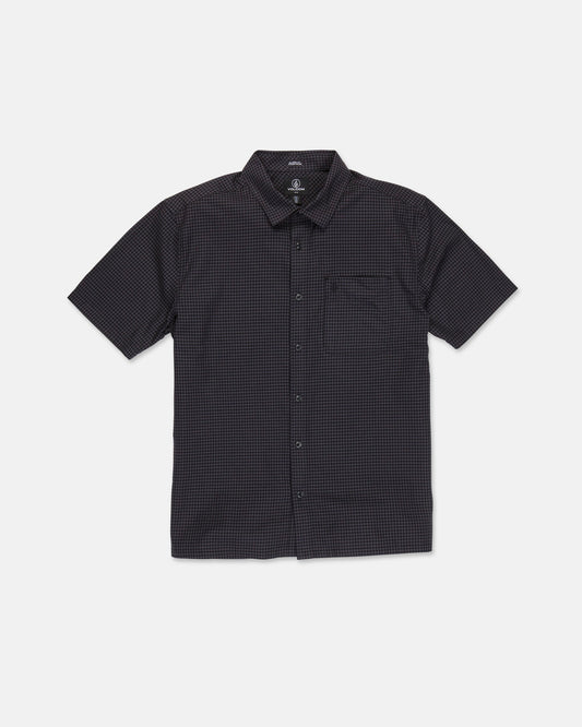 The Volcom Men's Glasnow Short Sleeve Shirt, shown laid flat on a white background, features a black cotton fabric with a subtle small yarn-dyed checkered pattern, button-up front, flat collar, and chest pocket.