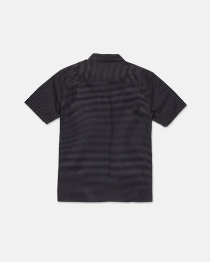 A Volcom Men's Glasnow Short Sleeve Shirt, featuring a small yarn-dyed checkered pattern in dark colors and made from cotton, is laid flat with the back side visible against a white background.