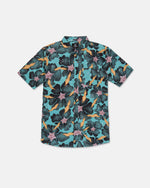 The Volcom Men's Concrete Jungle Short Sleeve Shirt features a bold, abstract pattern in teal, black, pink, and yellow. Crafted for a classic fit from breathable cotton-viscose fabric, this button-up shirt includes a collar and is displayed laid flat on a white background. Perfect for those who appreciate the vibrant appeal of a floral print with modern flair.