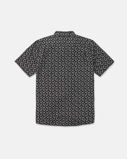 The Volcom Men's Scaler Stone Short Sleeve Shirt, featuring a black background with a white geometric pattern, is shown from the back.