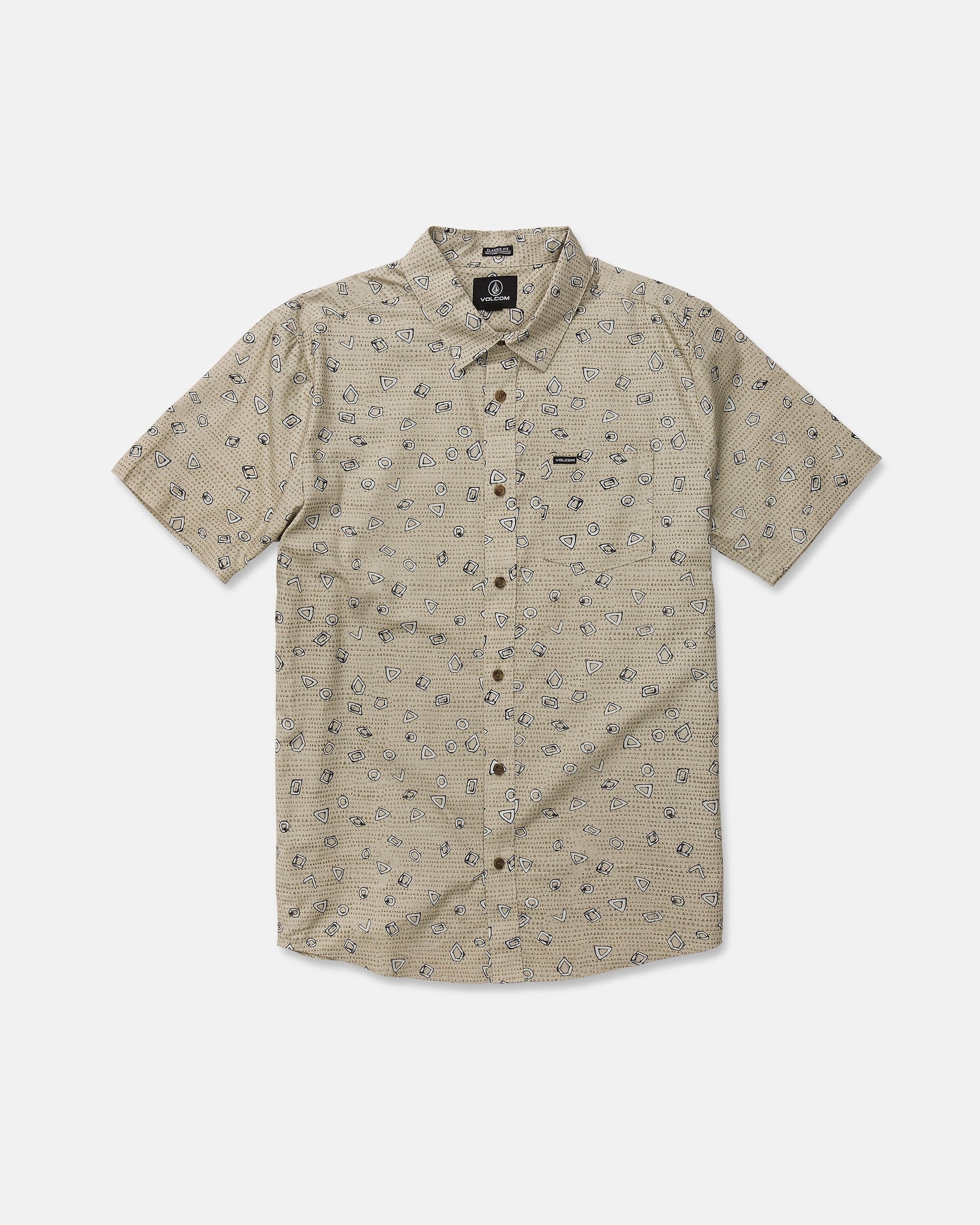 The Men’s Scaler Stone Short Sleeve Shirt by Volcom is a beige, classic-fit shirt featuring short sleeves and a subtle all-over print of small black geometric shapes. Made from a comfortable cotton-viscose blend, it includes a front pocket on the left chest adorned with a small black Volcom logo tag. The shirt is displayed laid flat on a white background.