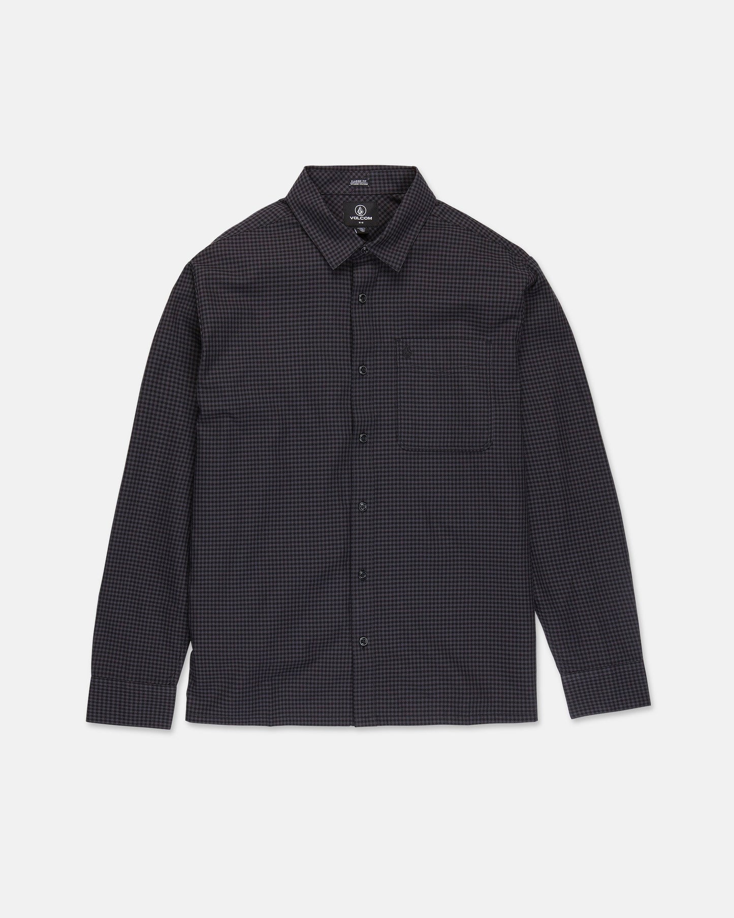 The Volcom Men's Glasnow Long Sleeve Shirt is a button-up, boxy fit style featuring a small black and dark blue checkered pattern, collar, and chest pocket. Crafted from yarn-dyed dobby texture fabric, it is shown laid flat against a white background.