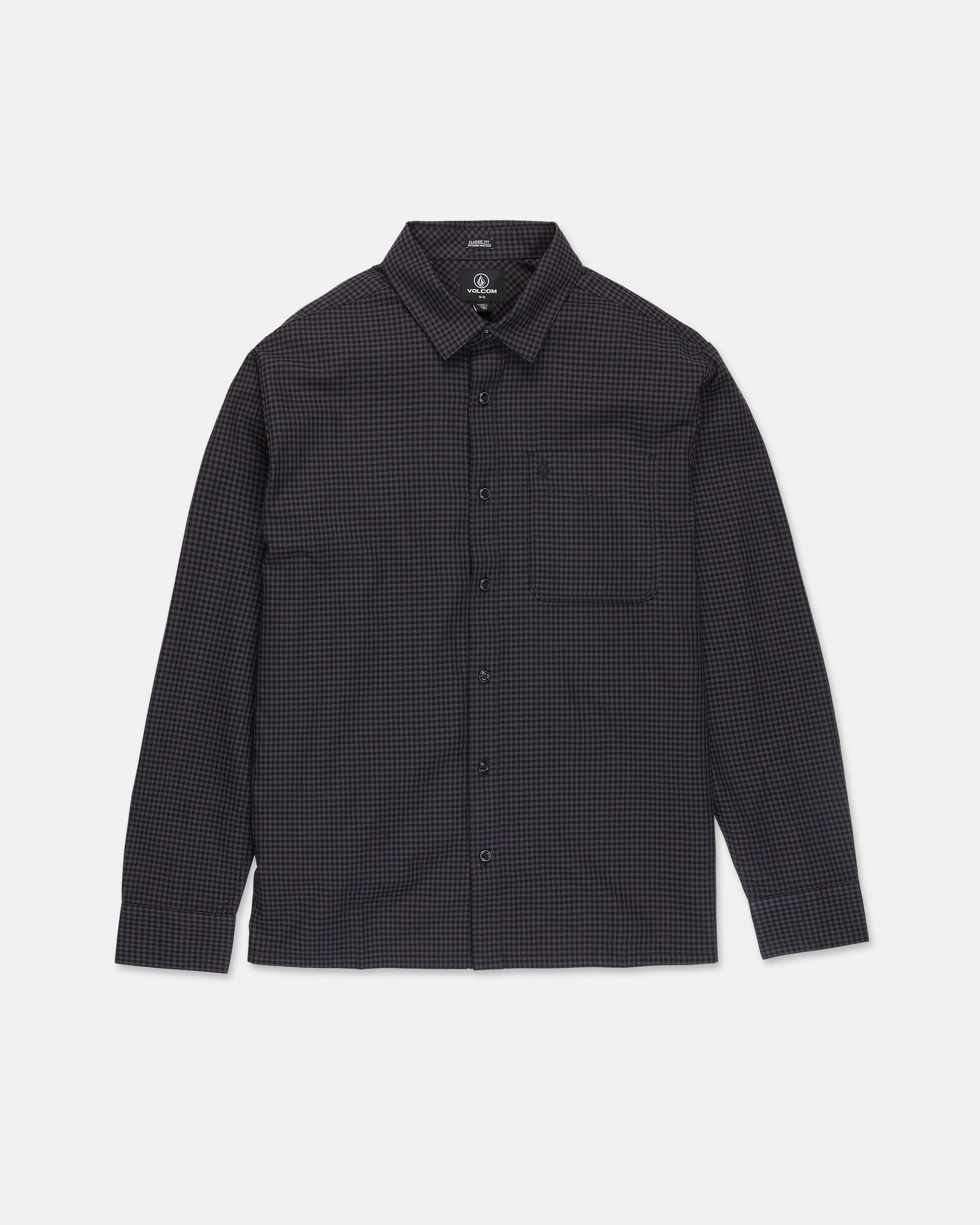 The Volcom Men's Glasnow Long Sleeve Shirt is a button-up, boxy fit style featuring a small black and dark blue checkered pattern, collar, and chest pocket. Crafted from yarn-dyed dobby texture fabric, it is shown laid flat against a white background.