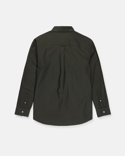 The Men's Veeco Oxford Long Sleeve Shirt by Volcom is pictured from the back in Climbing Ivy green, showcasing a classic fit with a collar, buttoned cuffs, and a central pleat beneath the yoke. Made from soft micro suede fabric, it combines comfort with timeless style.