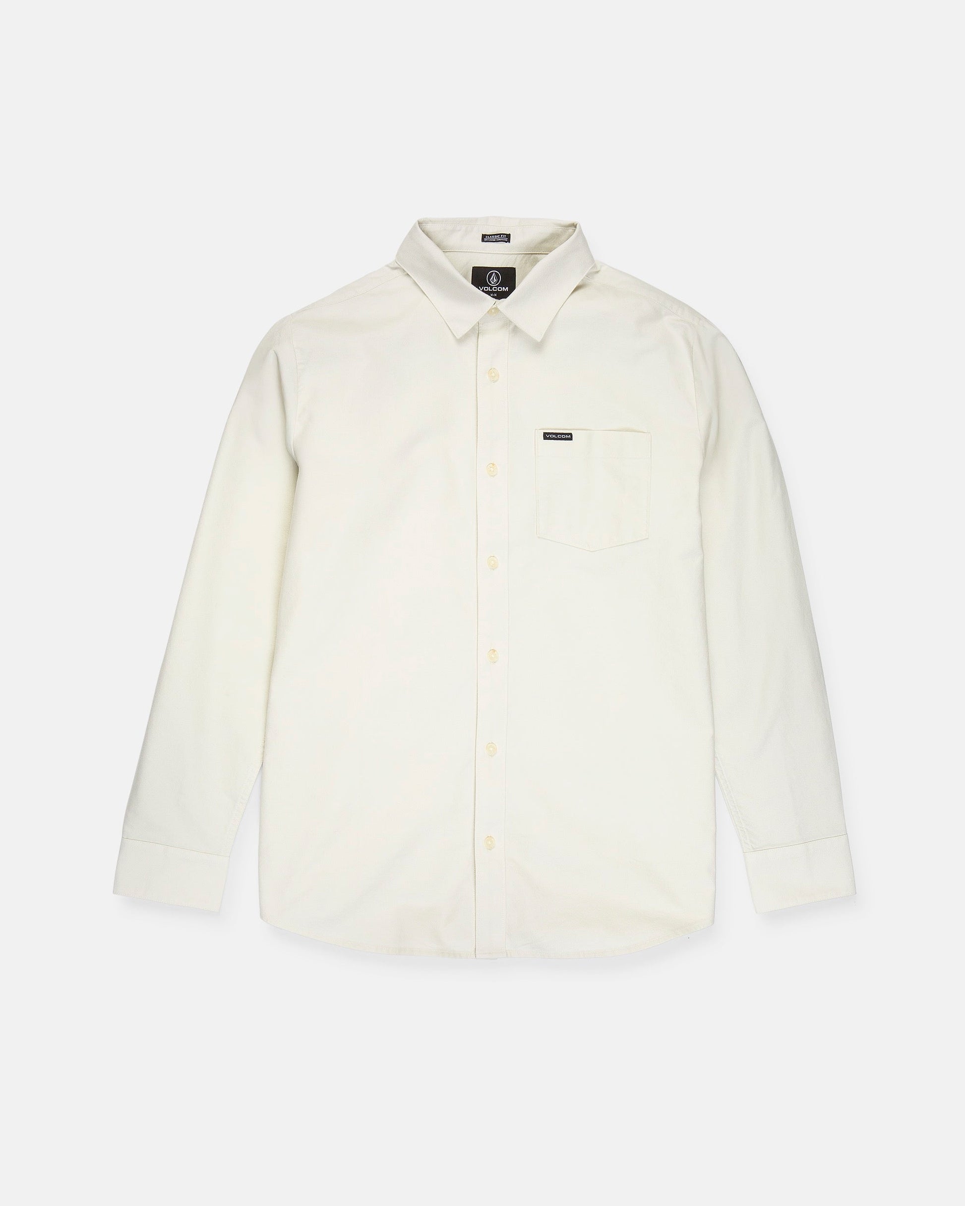 A Volcom Men's Veeco Oxford Long Sleeve Shirt in plain off-white, featuring a classic fit with a pointed collar and single chest pocket, is laid flat on a white background.
