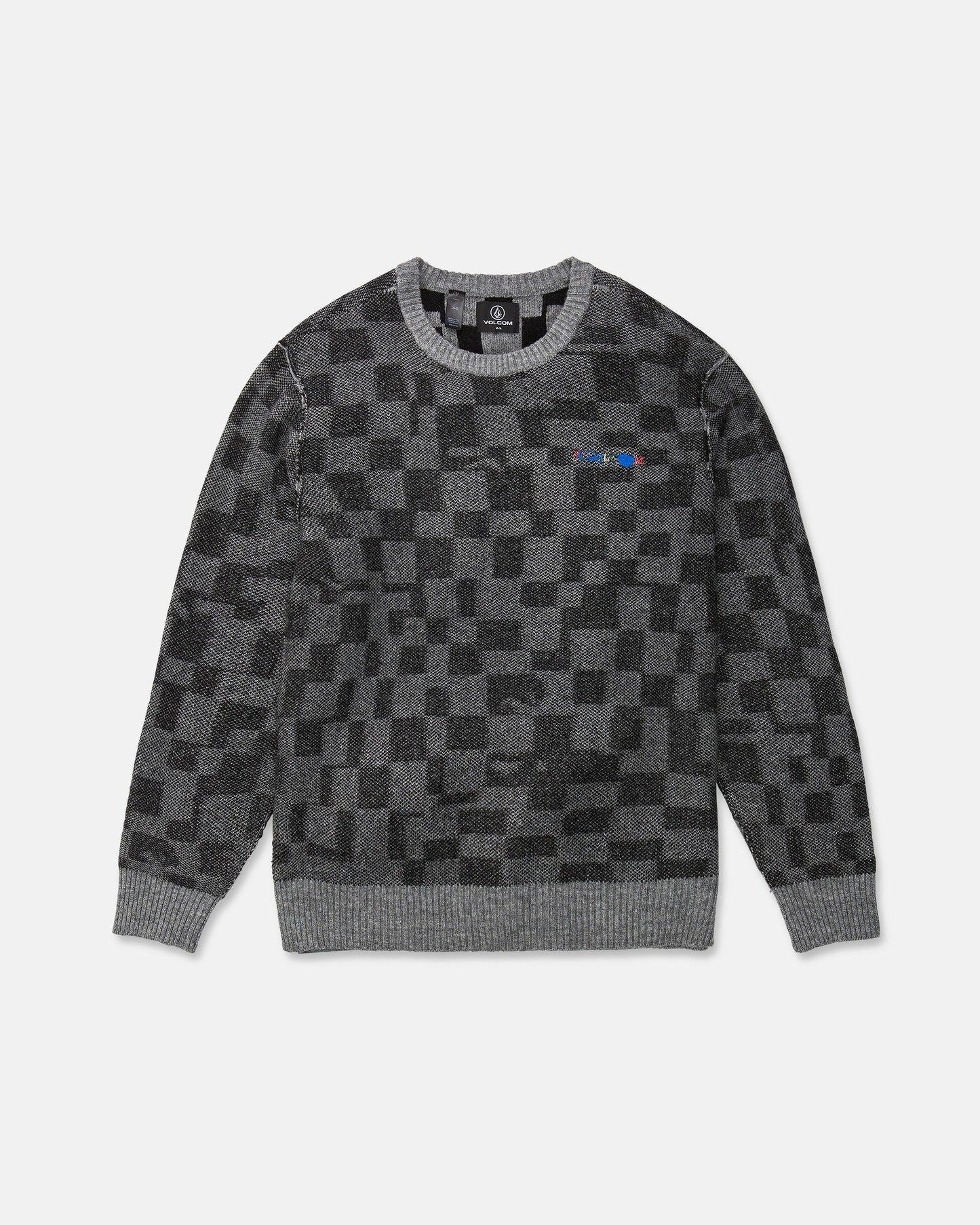 The Volcom Men's Featured Artist Antonio Carrau Sweater is a gray jacquard sweater with a black checkered pattern, ribbed cuffs and hem, and a small multicolored logo on the left chest. This sweater features a boxy fit and is shown laid flat on a white background.