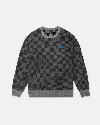 The Volcom Men's Featured Artist Antonio Carrau Sweater is a gray jacquard sweater with a black checkered pattern, ribbed cuffs and hem, and a small multicolored logo on the left chest. This sweater features a boxy fit and is shown laid flat on a white background.
