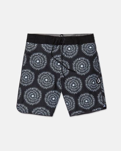 Men's Barnacle Stoney board shorts by Volcom, featuring a black base with a white and gray circular geometric pattern, a black drawstring waistband, and a small white Volcom logo on the left leg. Made from a comfortable hemp-cotton blend, these shorts are displayed flat on a white background.