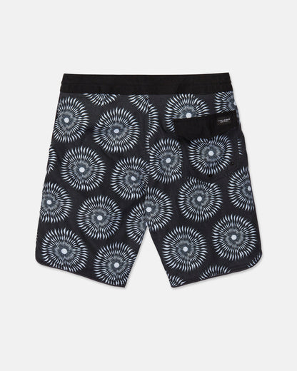 The Men's Barnacle Stoney shorts by Volcom feature a black base with a white geometric circular pattern, a solid black waistband, and a back pocket adorned with a small label. Expertly crafted from a durable hemp-cotton blend, these shorts are displayed laid flat against a white background.