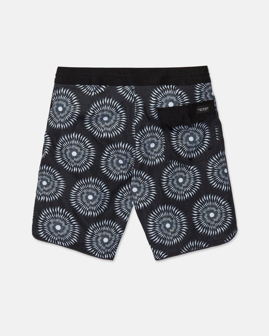 The Men's Barnacle Stoney shorts by Volcom feature a black base with a white geometric circular pattern, a solid black waistband, and a back pocket adorned with a small label. Expertly crafted from a durable hemp-cotton blend, these shorts are displayed laid flat against a white background.