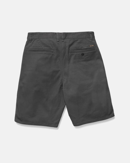 Men's Billow Shorts by Volcom in dark gray, shown from the back, feature two welt back pockets (one with button), a brand label above the right pocket, and are crafted from castlerock twill against a plain light background.