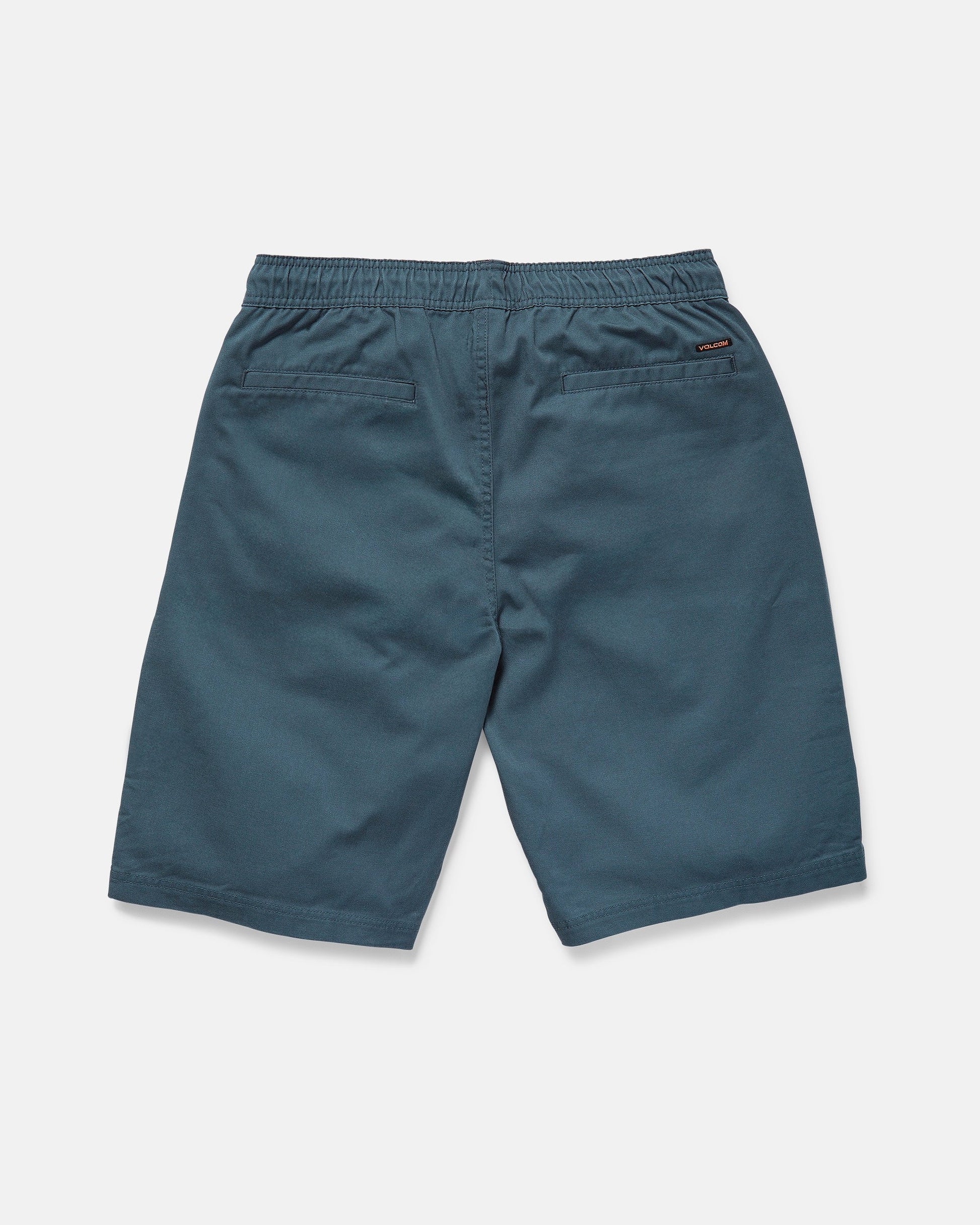 The rear view shows Volcom Men's Freazy Loose Elastic Waist 22" Shorts in blue-green corduroy with a 22-inch outseam, two back welt pockets, and a stitched logo tag on the right pocket against a plain white background.