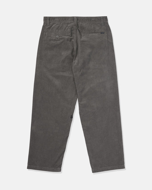 Back view of Volcom Men's Frickin Loose Tapered Cord Pants in dark gray, featuring two back pockets—one with a button closure—displayed on a plain white background.