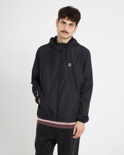 A young man with short dark hair and a mustache wears the Volcom Men's Wavern Jacket, featuring a small circular chest logo, while standing against a plain white background with a neutral expression.