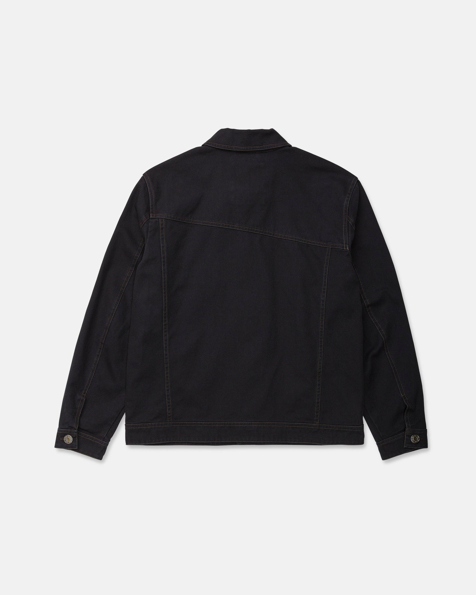 The Men's Slakers Jacket by Volcom is pictured from the back in black denim, showcasing long sleeves, brown stitching, a straight hem, and buttoned cuffs. Designed as a lightweight jacket, it is set against a plain white background.