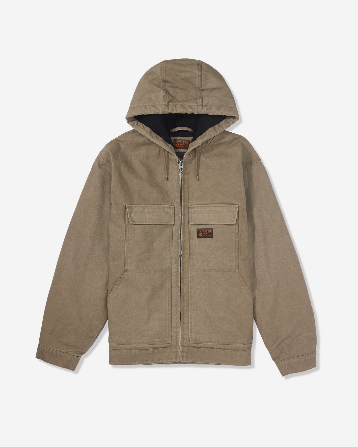 The Volcom Men's Freshdust Workwear Jacket in tan features a zip front, large flap hand and chest pockets, a small rectangular patch on the left chest, and long sleeves. Shown on a white background.