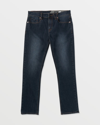 The Volcom Men's Vorta Denim features dark blue straight-leg jeans with classic five-pocket styling, visible stitching, and a button closure, shown laid flat on a white background.