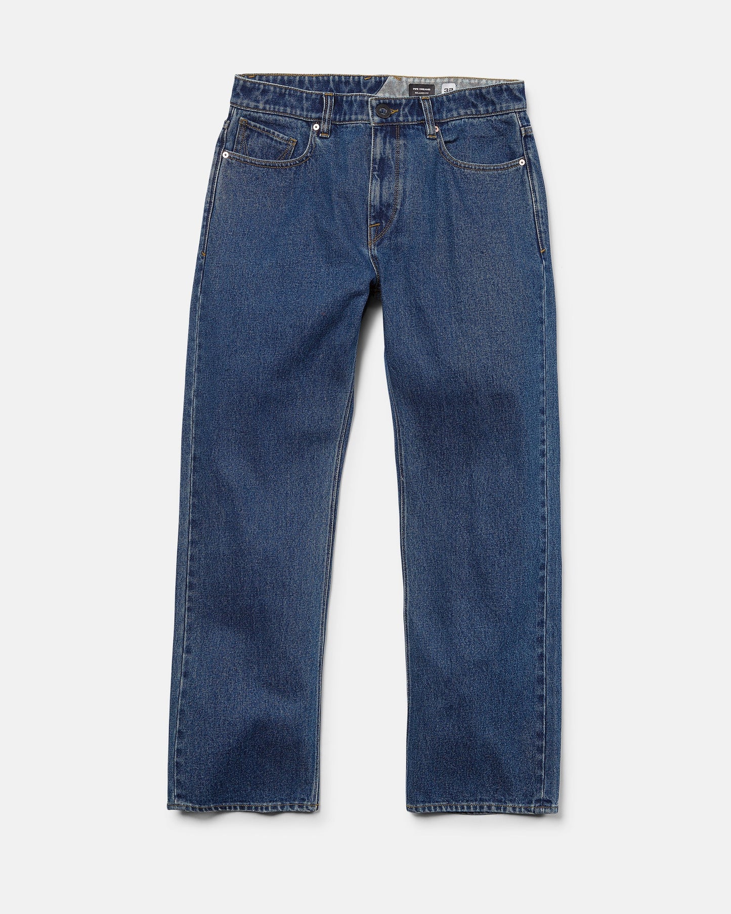 A pair of Volcom Men's Pipe Dreams Denim Pants in dark indigo, featuring a relaxed straight fit and classic five-pocket design, laid flat on a white background.