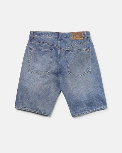 Back view of Volcom Men's Billow Denim Shorts in blue, featuring two large rear pockets, belt loops, and a brown leather patch on the waistband. These shorts offer a loose fit and a slightly faded look.
