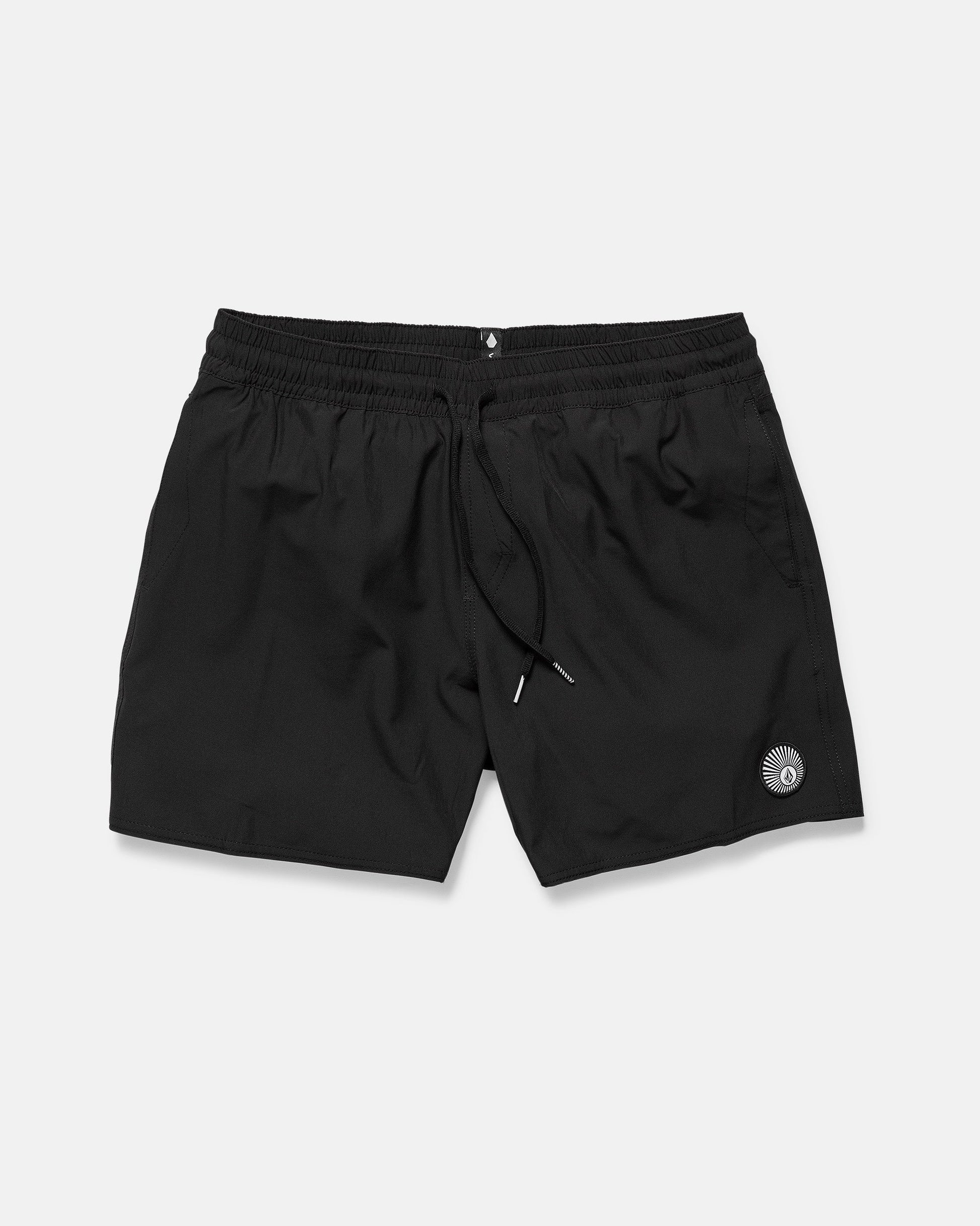 The Volcom Men's Lido 2 Solid Trunks are black athletic shorts made from recycled polyester, featuring an elastic waistband, drawstring, and a small circular logo on the left leg, shown on a plain white background.
