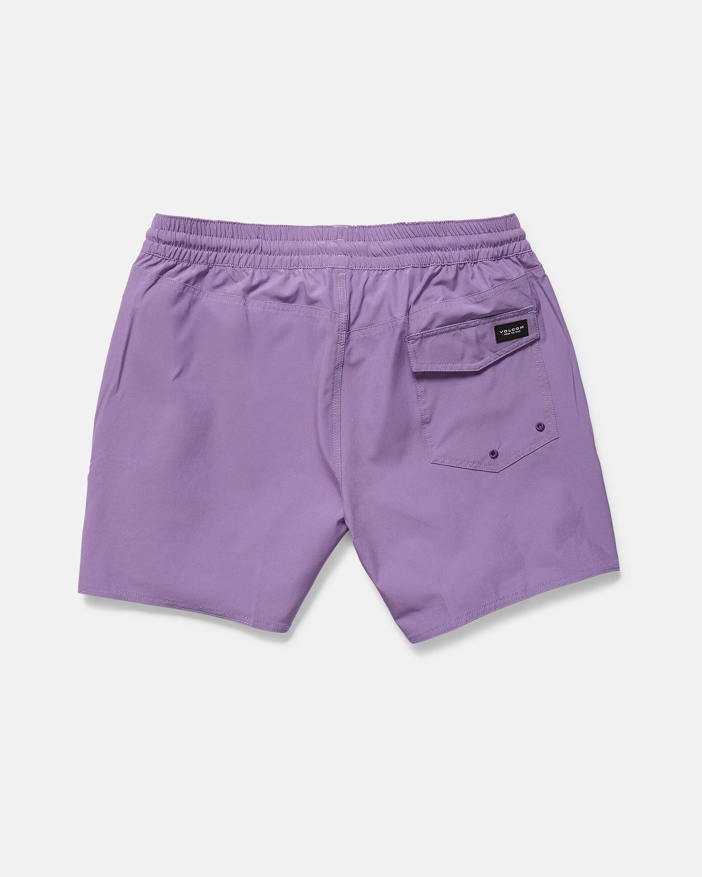 The Volcom Men's Lido Solid 16" Trunk, in purple recycled polyester, features an elastic waistband, two side pockets, and a back flap pocket with button and black label. The swim trunks are laid flat on a white background.