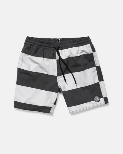 The Volcom Men's Psyche Cotton 17" Trunk features wide black and white stripes, an elastic waistband with black drawstring, side pockets, a logo on the left leg, and a classic 17-inch outseam.