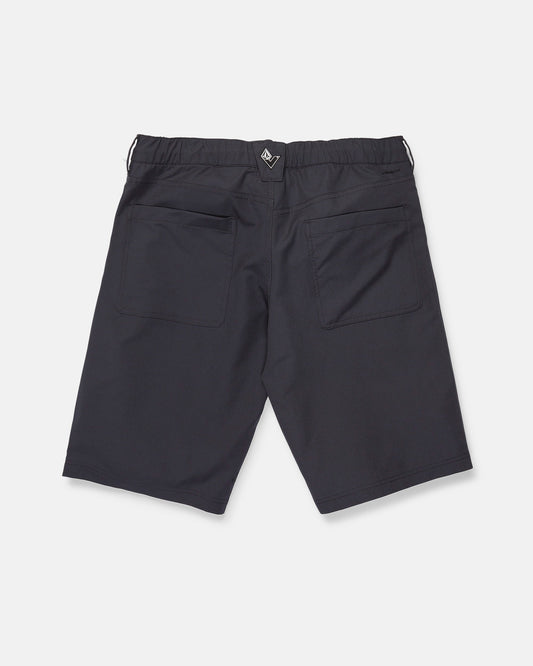 Back view of Volcom Men's Venture Stone Hybrid Shorts in Asphalt Black, crafted from recycled-poly fabric. The shorts feature two rear patch pockets, an elastic waistband, and a small black and white tag at the center back. Displayed against a plain white background.