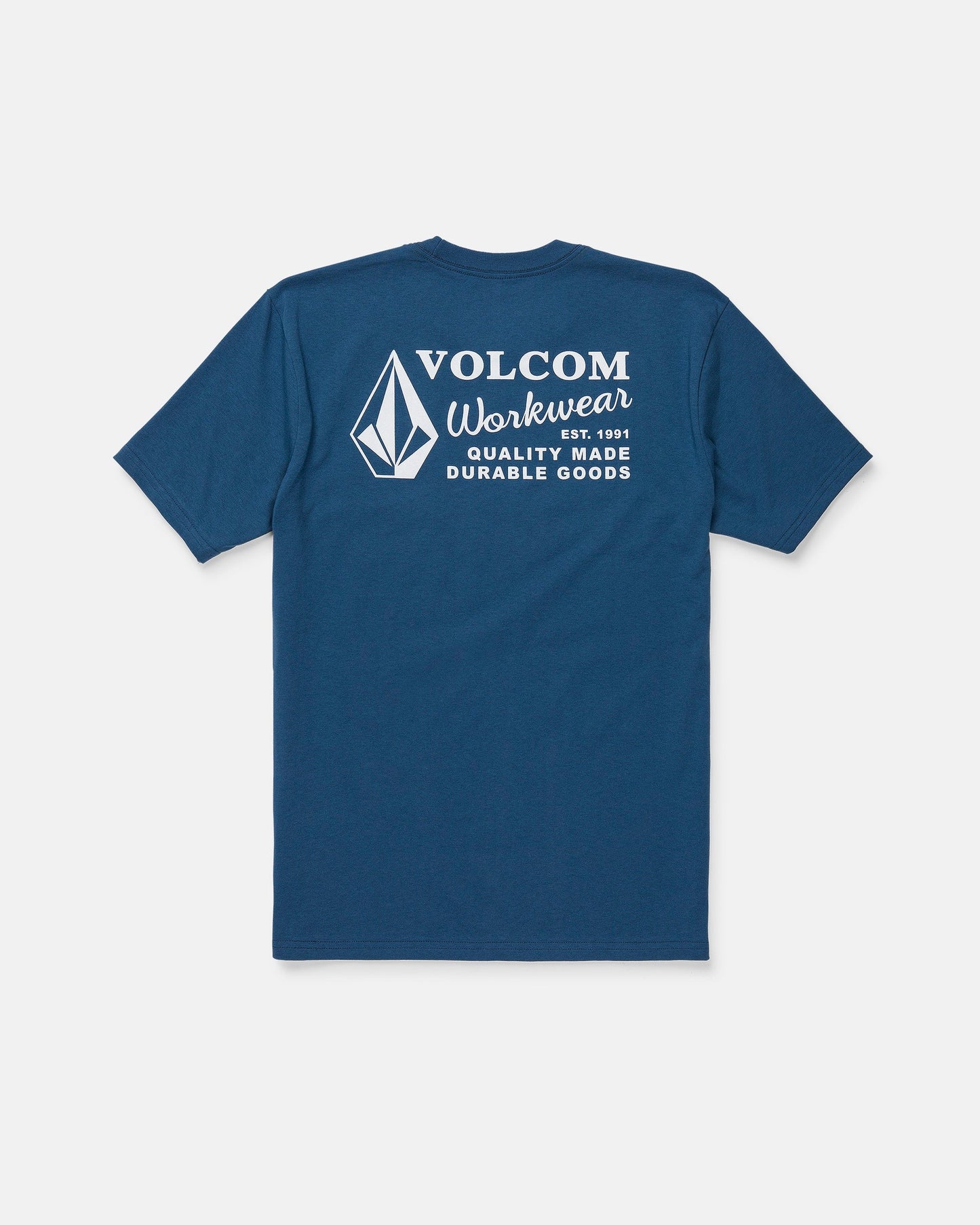 The Men's Volcom Workwear Short Sleeve Tee by Volcom is featured in blue, displayed from the back with a white diamond emblem and logo. The upper back showcases the text “Volcom Workwear, Quality Made Durable Goods.” Crafted from heavy-weight cotton, this classic fit tee is designed for long-lasting comfort and durability.