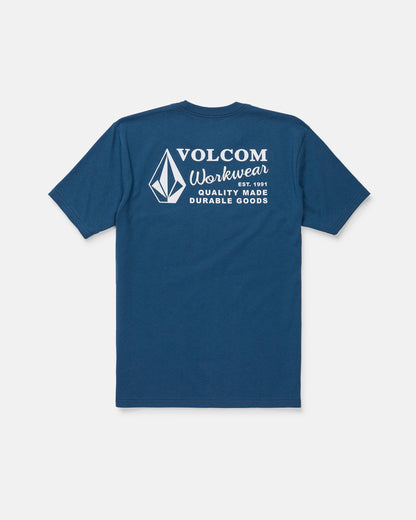 The Men's Volcom Workwear Short Sleeve Tee by Volcom is featured in blue, displayed from the back with a white diamond emblem and logo. The upper back showcases the text “Volcom Workwear, Quality Made Durable Goods.” Crafted from heavy-weight cotton, this classic fit tee is designed for long-lasting comfort and durability.