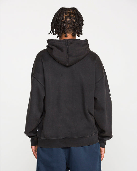 A person with short twisted hair is seen from behind, wearing the Men's Stone Trip Pullover by Volcom—a loose, heavyweight fleece tribal hoodie—paired with dark blue pants, standing against a plain white background.