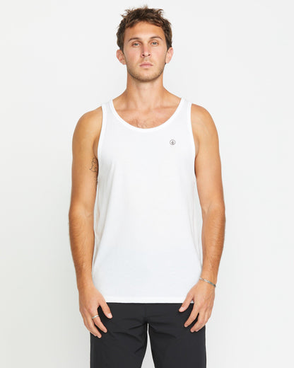A man with short brown hair wears a Volcom Men's Solid Heather Tank in white and black pants, standing facing forward against a plain white background.