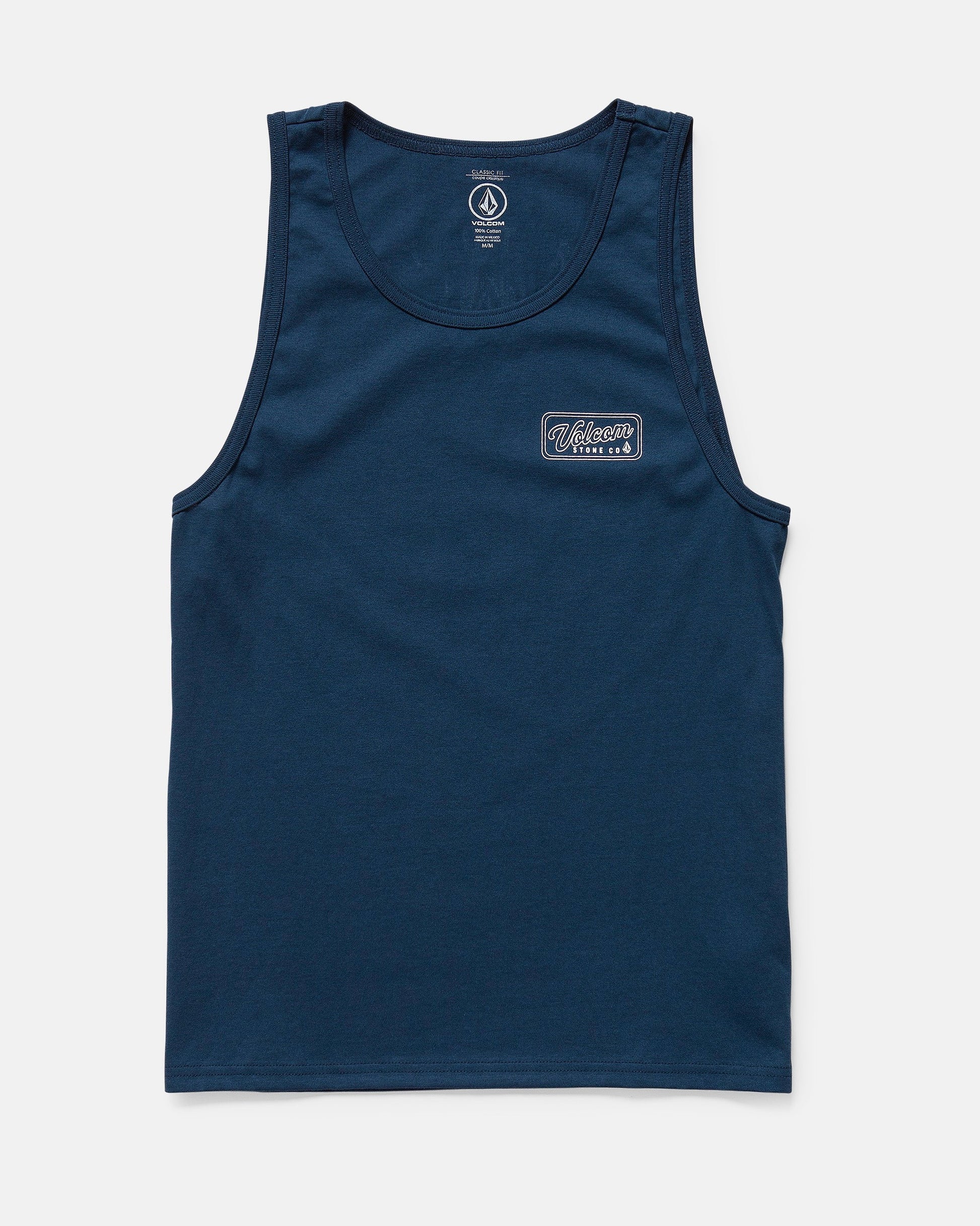 The Volcom Men's Wrecking Tank is a navy blue, sleeveless, classic-fit shirt made of 100% cotton. It has a small rectangular patch with white and blue text on the left chest and is shown laid flat on a white background.